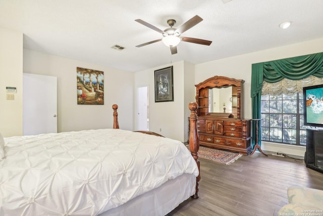 bedroom featuring hardwood / wood-style flooring, ceiling fan, and a textured ceiling