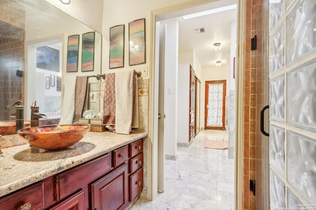 bathroom featuring vanity and an enclosed shower