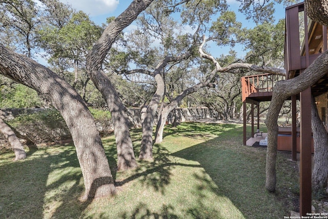 view of yard with a hot tub and a wooden deck