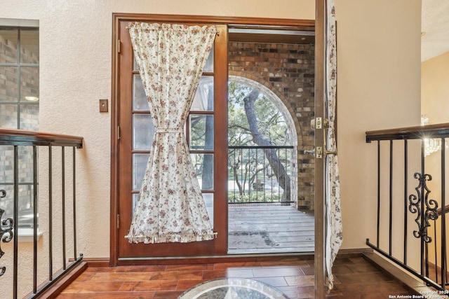 doorway to outside featuring dark wood-type flooring