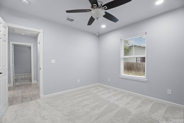 carpeted spare room with ceiling fan