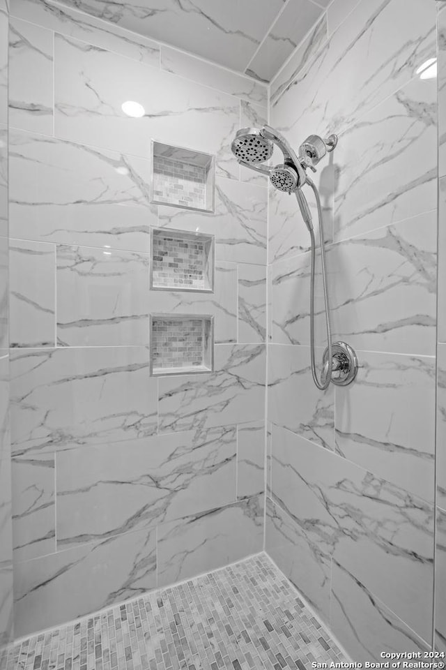 bathroom with tiled shower