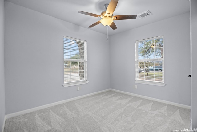 spare room with light colored carpet and ceiling fan