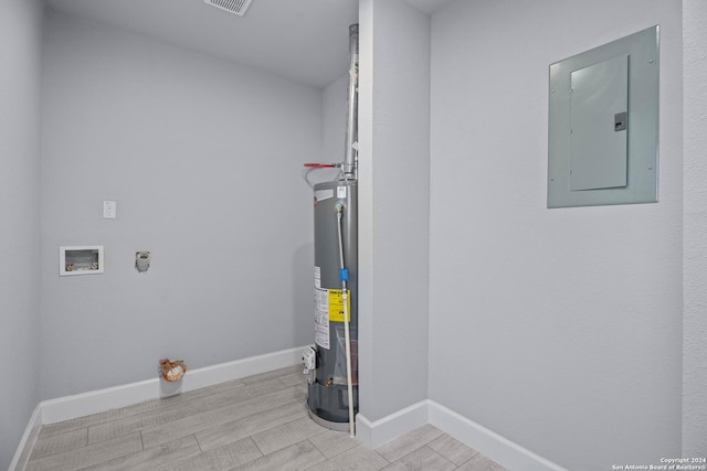 laundry area featuring electric dryer hookup, electric panel, washer hookup, water heater, and light hardwood / wood-style floors