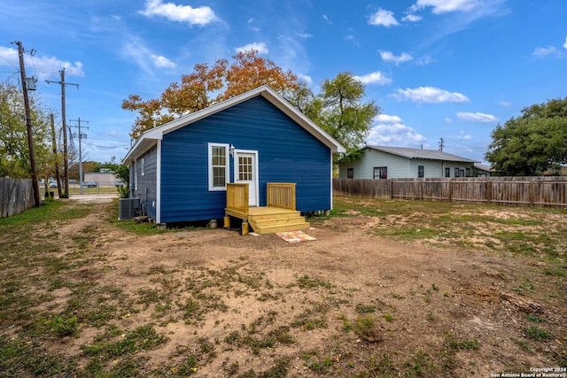 rear view of property featuring central air condition unit