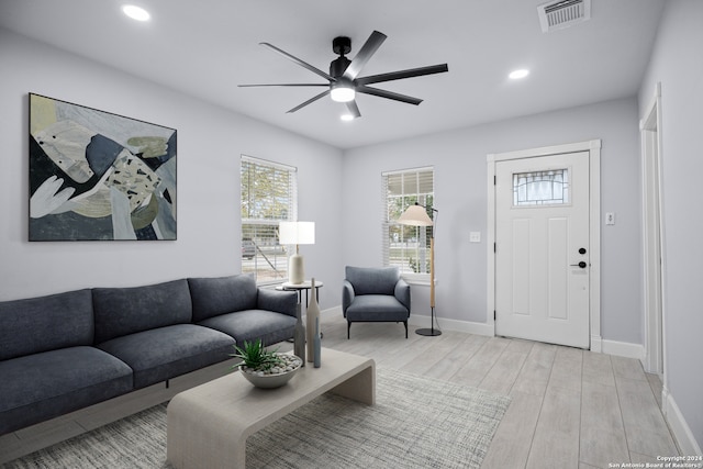 living room featuring ceiling fan and light hardwood / wood-style flooring