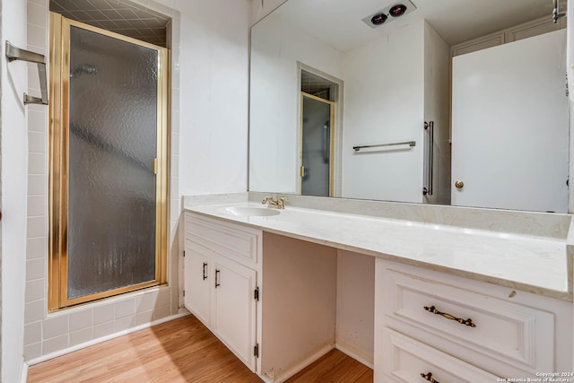 bathroom featuring vanity, hardwood / wood-style flooring, and an enclosed shower