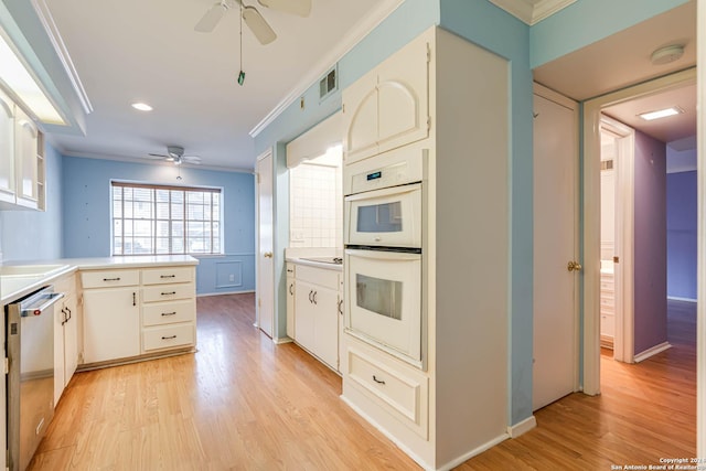 kitchen featuring kitchen peninsula, white double oven, light hardwood / wood-style floors, and white cabinetry