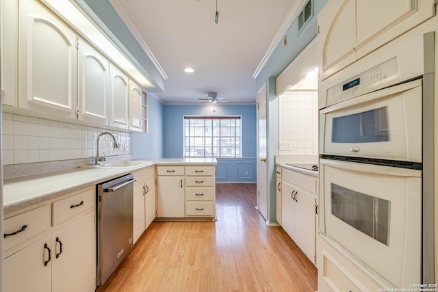 kitchen with ceiling fan, dishwasher, backsplash, light hardwood / wood-style floors, and ornamental molding