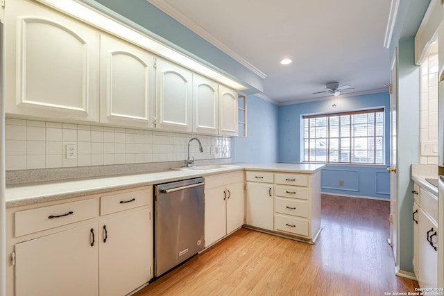 kitchen with sink, light hardwood / wood-style flooring, stainless steel dishwasher, kitchen peninsula, and ornamental molding