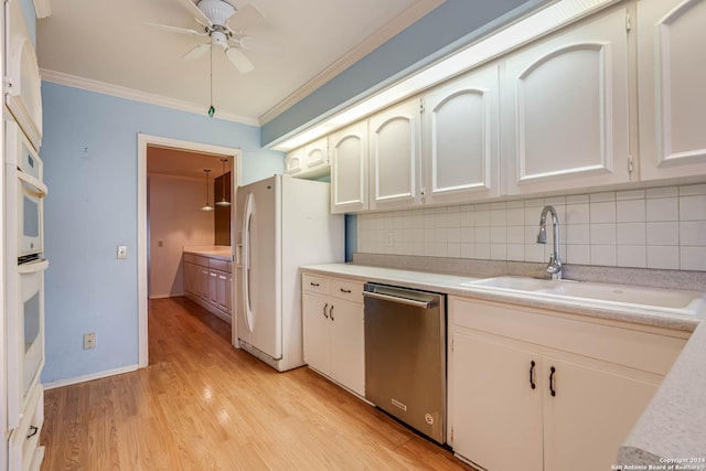 kitchen featuring dishwasher, white fridge with ice dispenser, ornamental molding, and sink