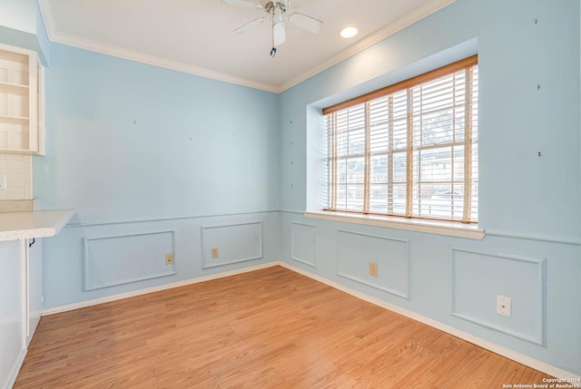 empty room with ceiling fan, light hardwood / wood-style flooring, and ornamental molding