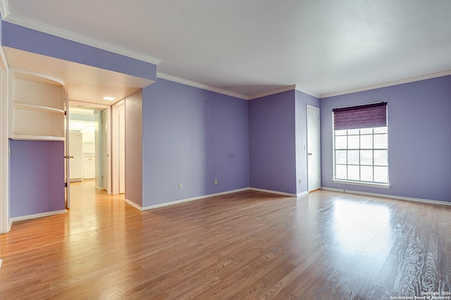 empty room featuring light hardwood / wood-style floors and ornamental molding