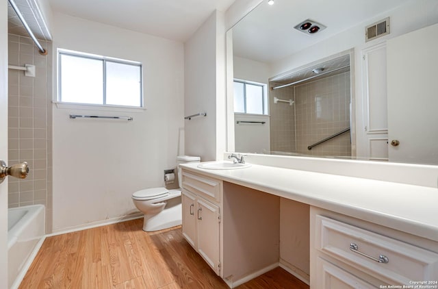 full bathroom with plenty of natural light, vanity, wood-type flooring, and toilet