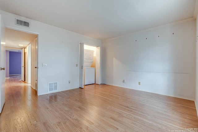 unfurnished room with light wood-type flooring and crown molding