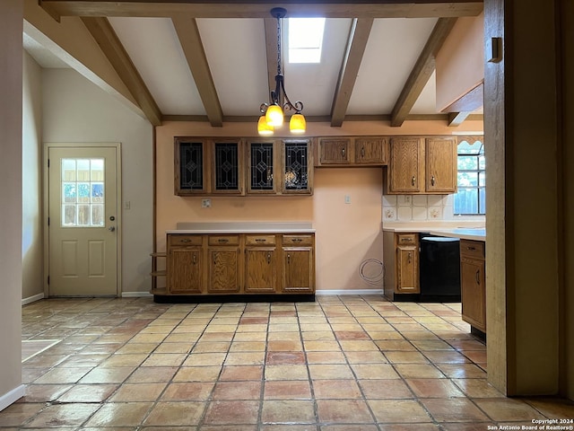 kitchen with plenty of natural light, beamed ceiling, pendant lighting, and black dishwasher