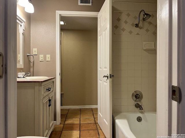 bathroom featuring vanity and tiled shower / bath combo