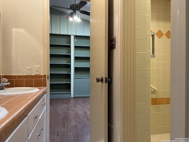 bathroom with hardwood / wood-style flooring, vanity, and ceiling fan