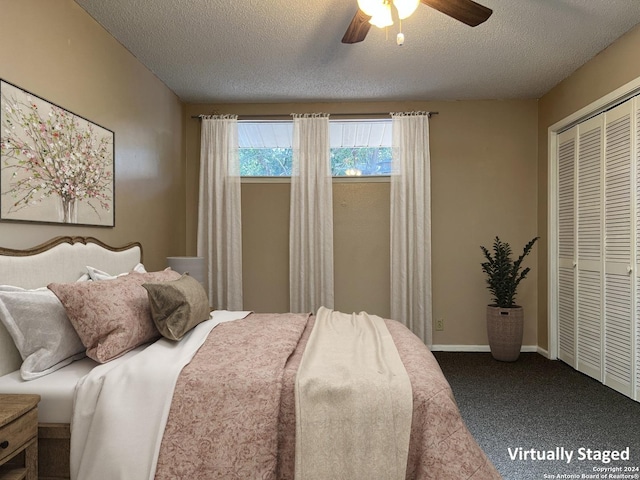 carpeted bedroom with ceiling fan, a closet, and a textured ceiling