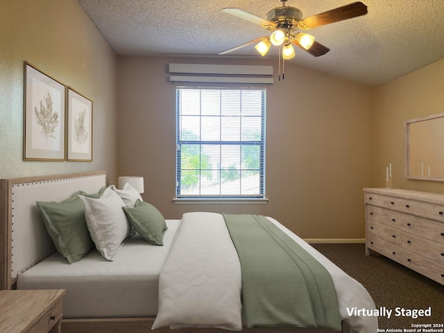 bedroom featuring ceiling fan, a textured ceiling, a wall mounted AC, and vaulted ceiling