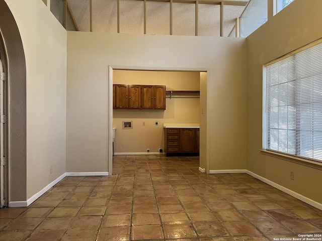 spare room with a towering ceiling