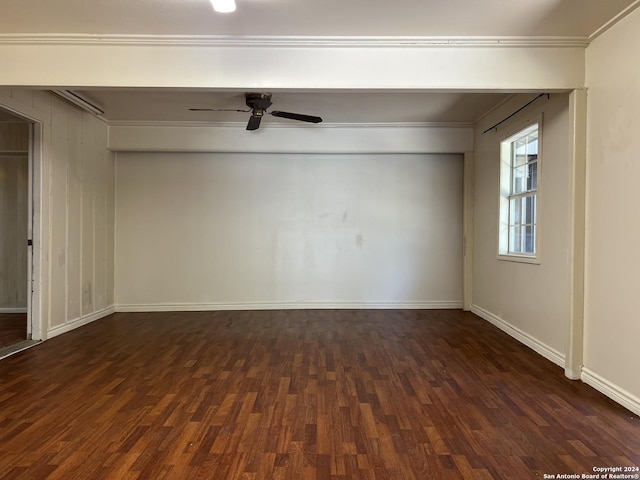 spare room with ceiling fan, crown molding, and dark wood-type flooring