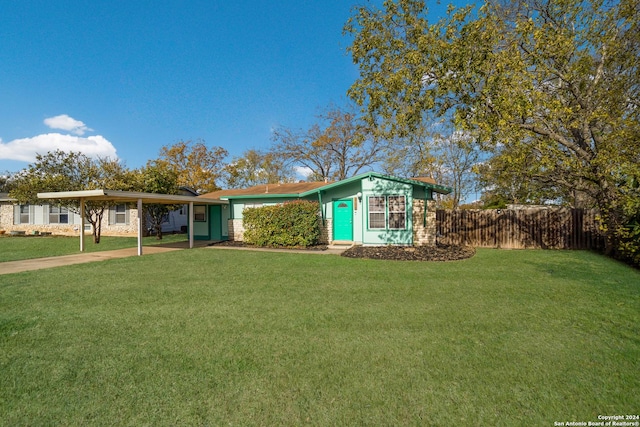 single story home featuring a carport and a front lawn