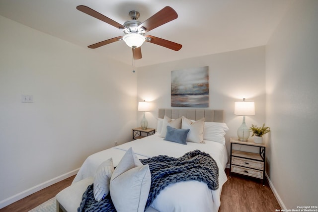 bedroom with ceiling fan and dark hardwood / wood-style floors