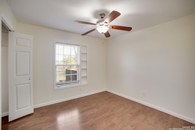 unfurnished bedroom with ceiling fan and wood-type flooring