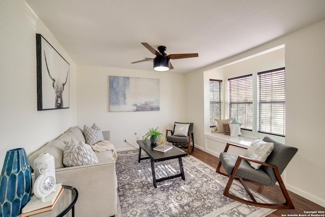 living room featuring hardwood / wood-style floors and ceiling fan