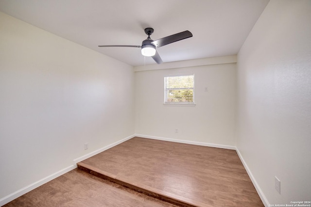 unfurnished room with ceiling fan and hardwood / wood-style floors