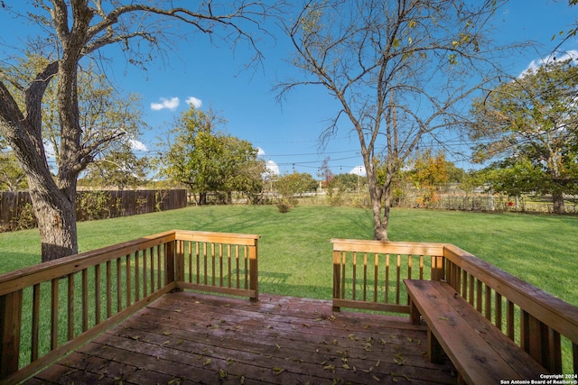 wooden deck with a lawn