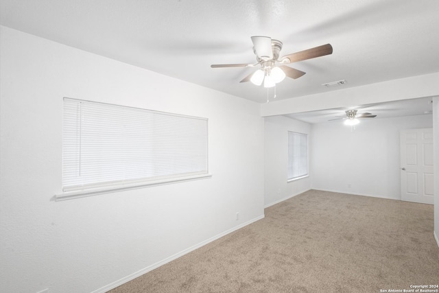 carpeted empty room featuring ceiling fan