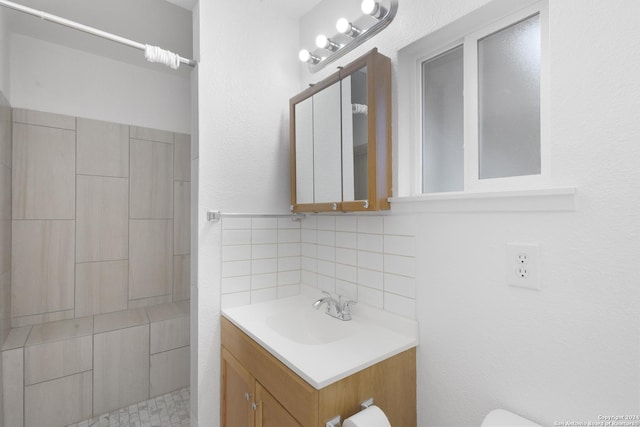 bathroom featuring tasteful backsplash and vanity