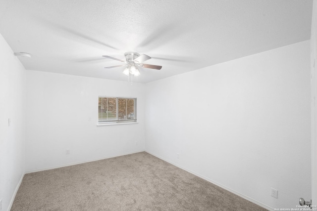 empty room with ceiling fan, carpet, and a textured ceiling