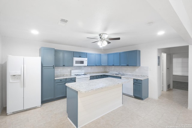 kitchen with backsplash, white appliances, blue cabinets, ceiling fan, and sink