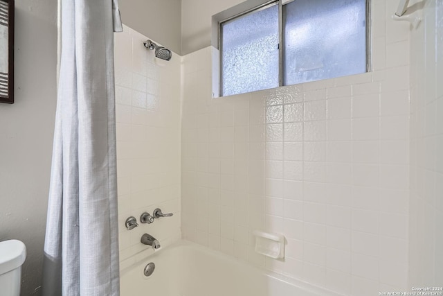 bathroom featuring shower / bath combo and toilet