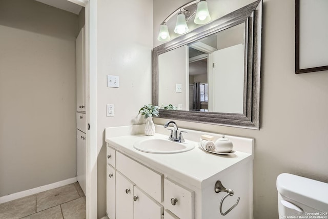 bathroom featuring tile patterned flooring, vanity, and toilet