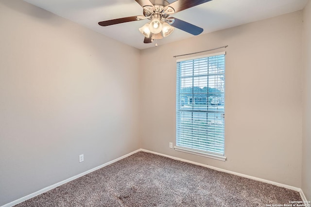 carpeted spare room featuring ceiling fan