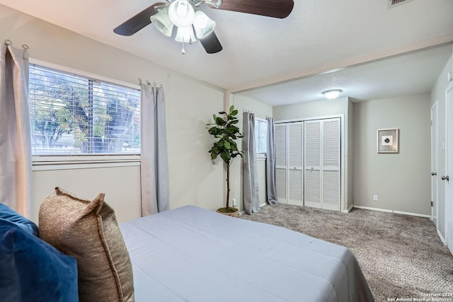 bedroom featuring carpet flooring, ceiling fan, and a closet