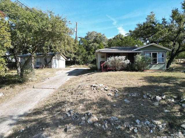 view of front facade featuring a garage and an outdoor structure