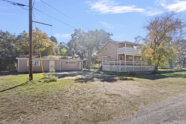 view of yard with a garage and an outbuilding