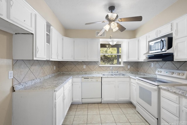 kitchen with white appliances, ventilation hood, sink, white cabinets, and light tile patterned flooring