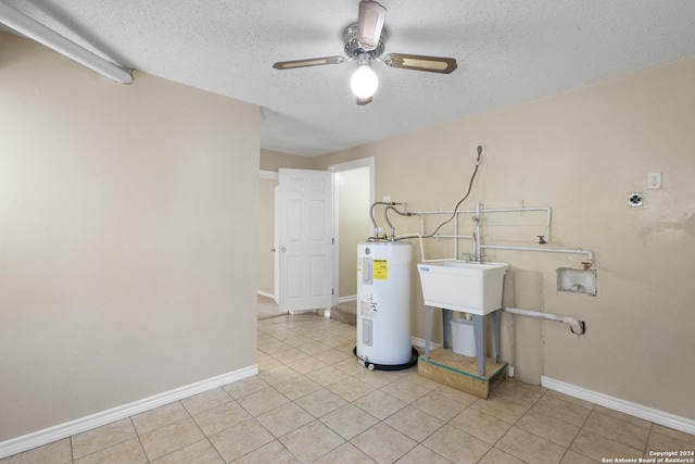 laundry room featuring washer hookup, a textured ceiling, ceiling fan, water heater, and light tile patterned floors