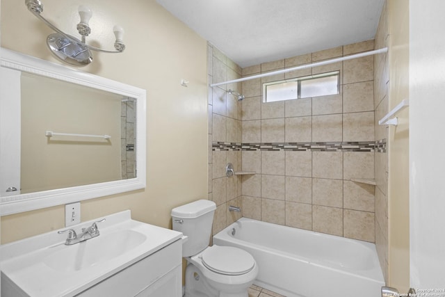 full bathroom with vanity, a textured ceiling, tiled shower / bath combo, and toilet