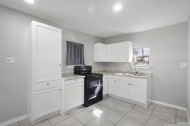 kitchen with white cabinetry, sink, light tile patterned flooring, and black range with electric cooktop