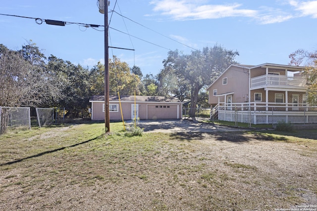 view of yard with a garage and an outbuilding