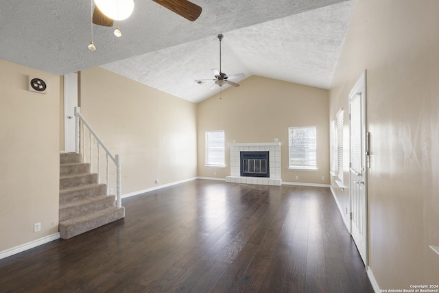 unfurnished living room with plenty of natural light, dark hardwood / wood-style floors, and ceiling fan