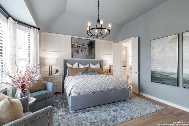 bedroom featuring connected bathroom, hardwood / wood-style floors, lofted ceiling, and a notable chandelier