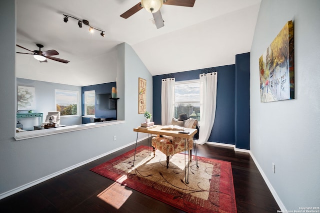 home office with vaulted ceiling, ceiling fan, and dark hardwood / wood-style floors